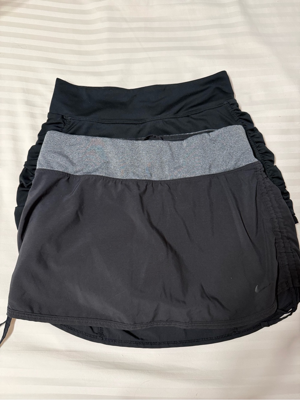 Two Nike Black Tennis Skirts 1 with Gray Waistband